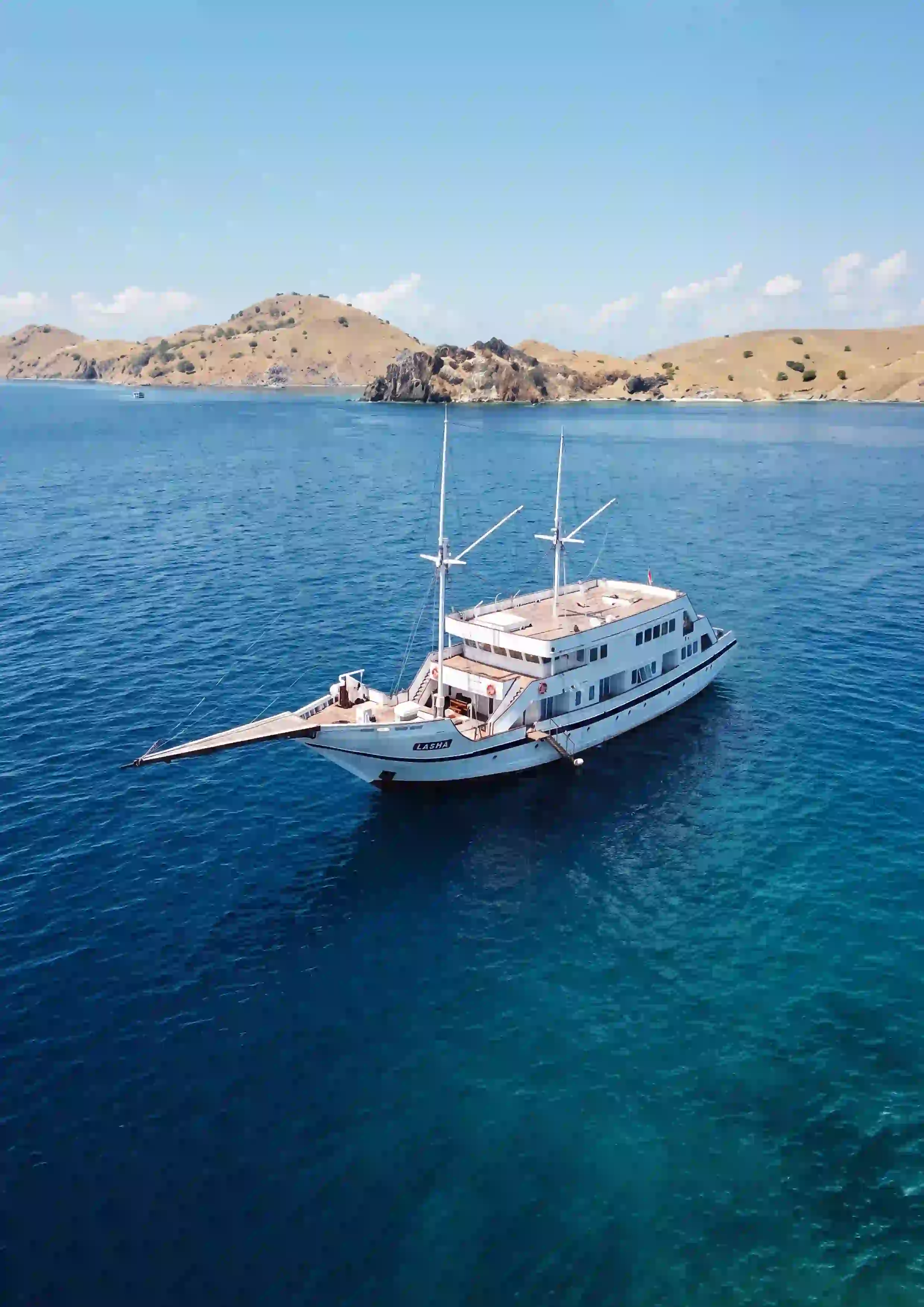 Lasha at anchor beside an island, seen from the air