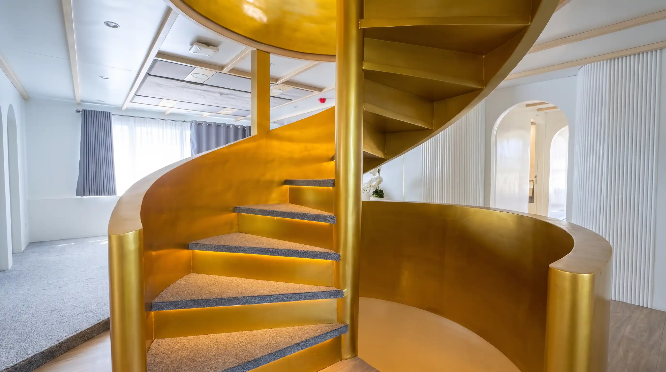 Gold spiral staircase aboard Lasha